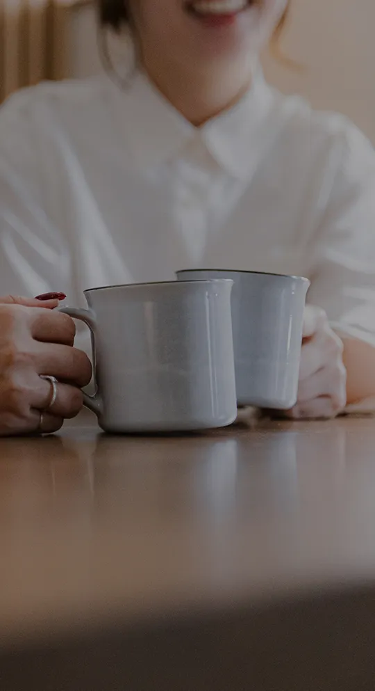 マグカップを持って楽しそうに会話する男女